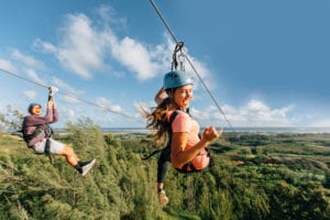 Two guests having fun at our Oahu zipline course.