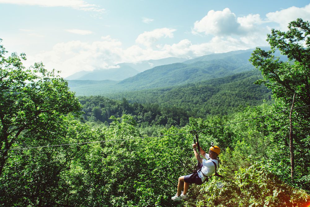 A man ziplining in the Smoky Mountains at CLIMB Works.