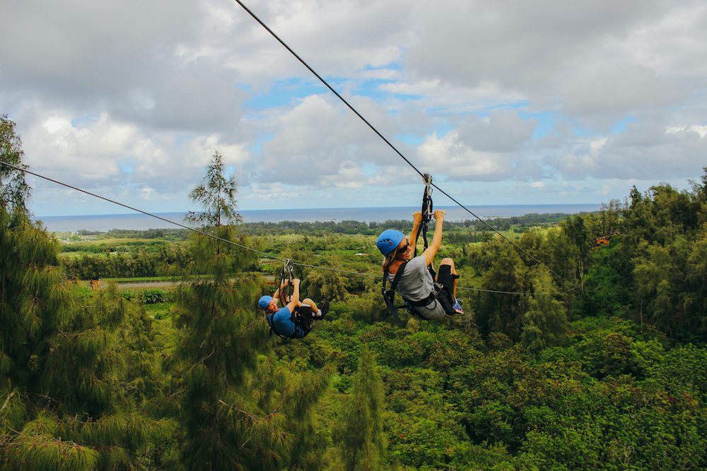 A couple ziplining together in Oahu.