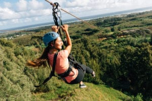 A young woman enjoying one of our ziplines in Oahu.