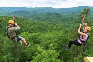Two friends enjoying the mountaintop ziplines in the Smoky Mountains.