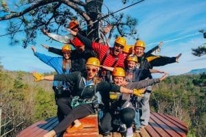 group of friends ziplining in the smoky mountains